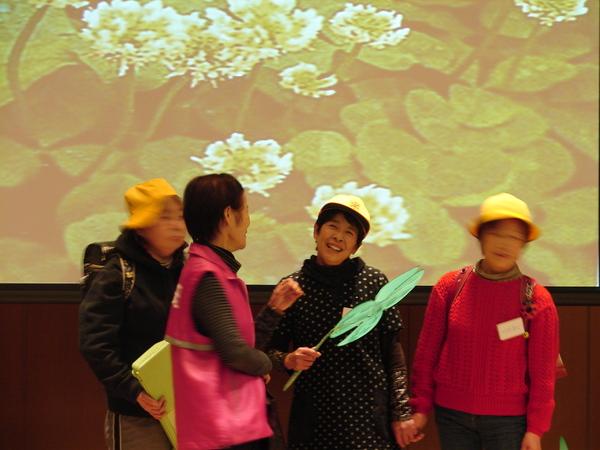 女性たちがランドセルを背負い笑顔で劇をしている写真